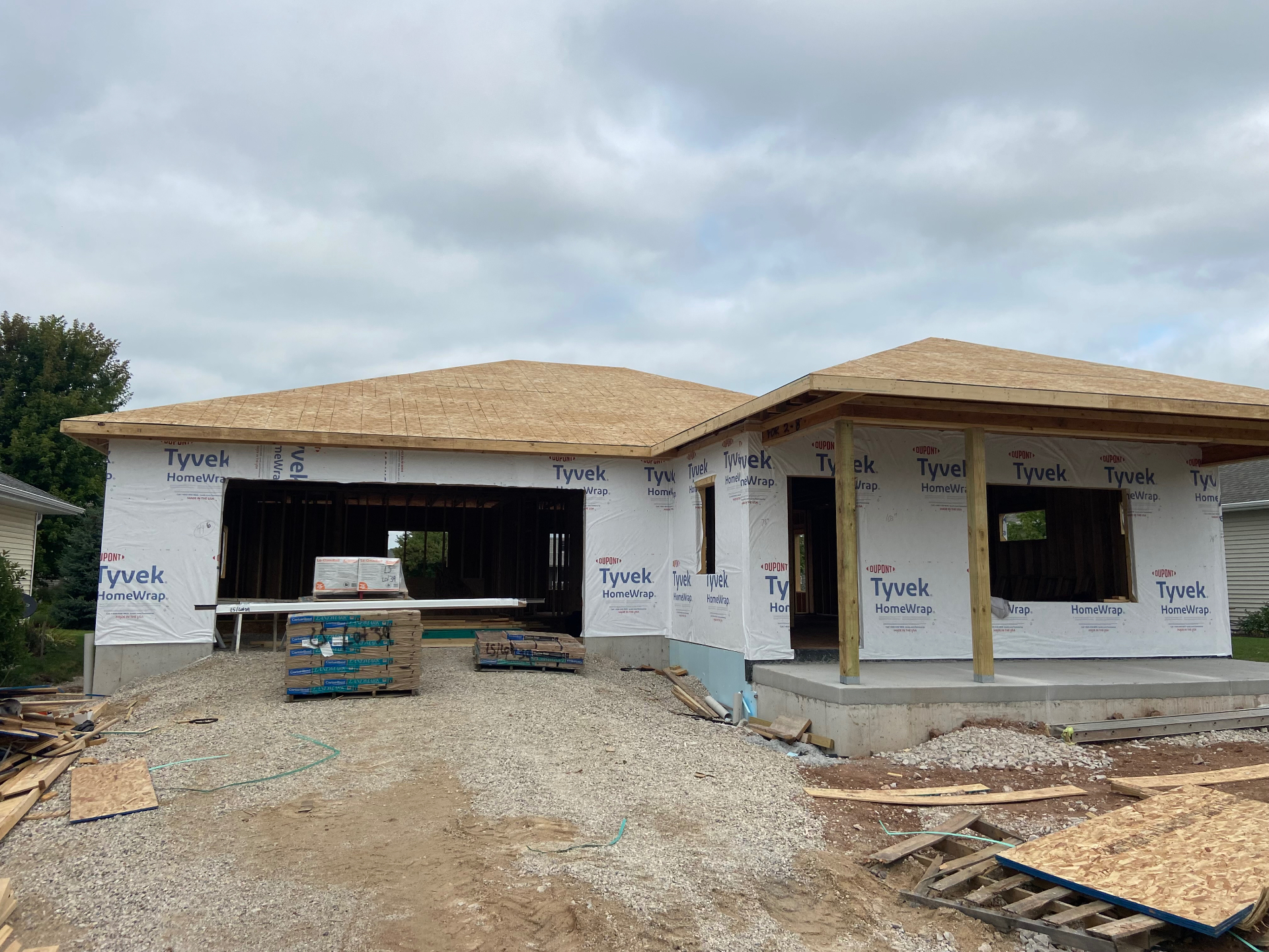 Ranch home framing with roof sheathing and covered porch
